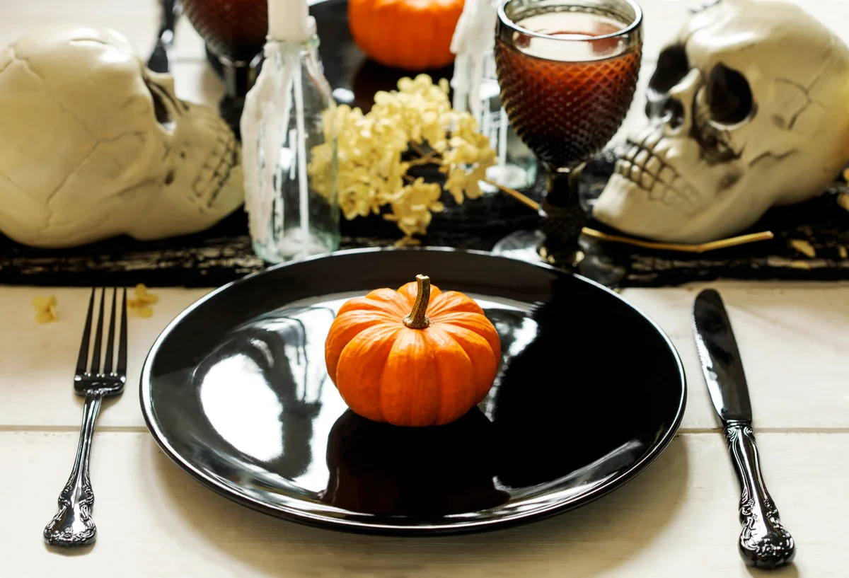 gothic dinner table setting with mini pumpkin