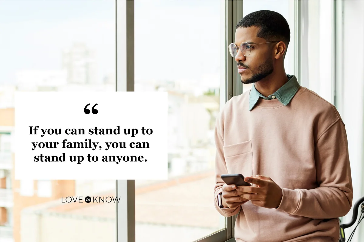 man looking out window inspired to stand up to family