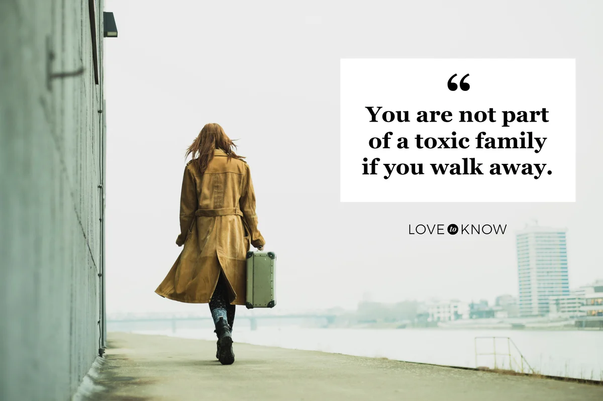woman walking away with suitcase in hand
