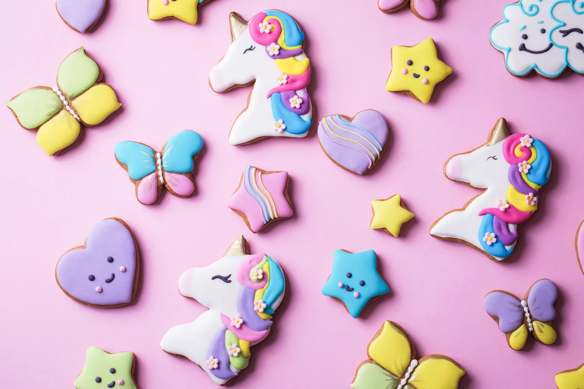 Festive gingerbread cookies with a icing on a pink background
