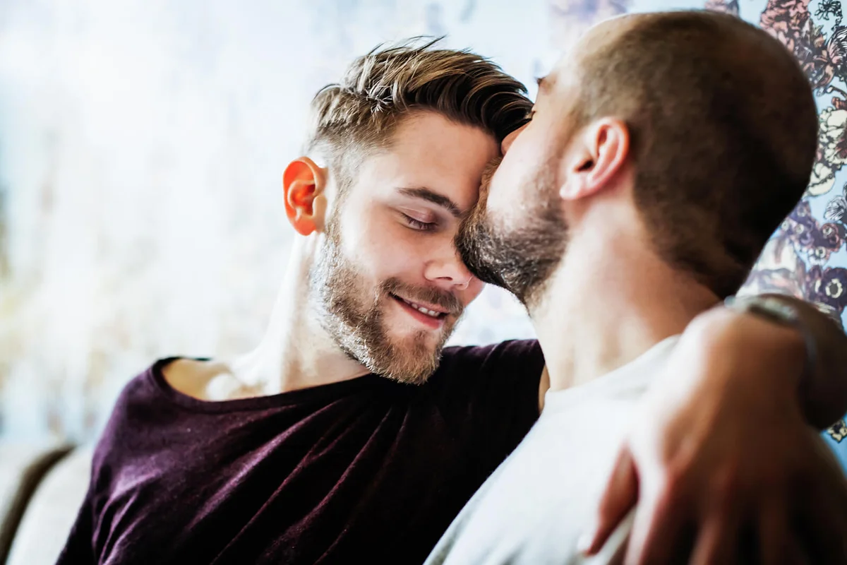 Man Kissing His Partner On The Head