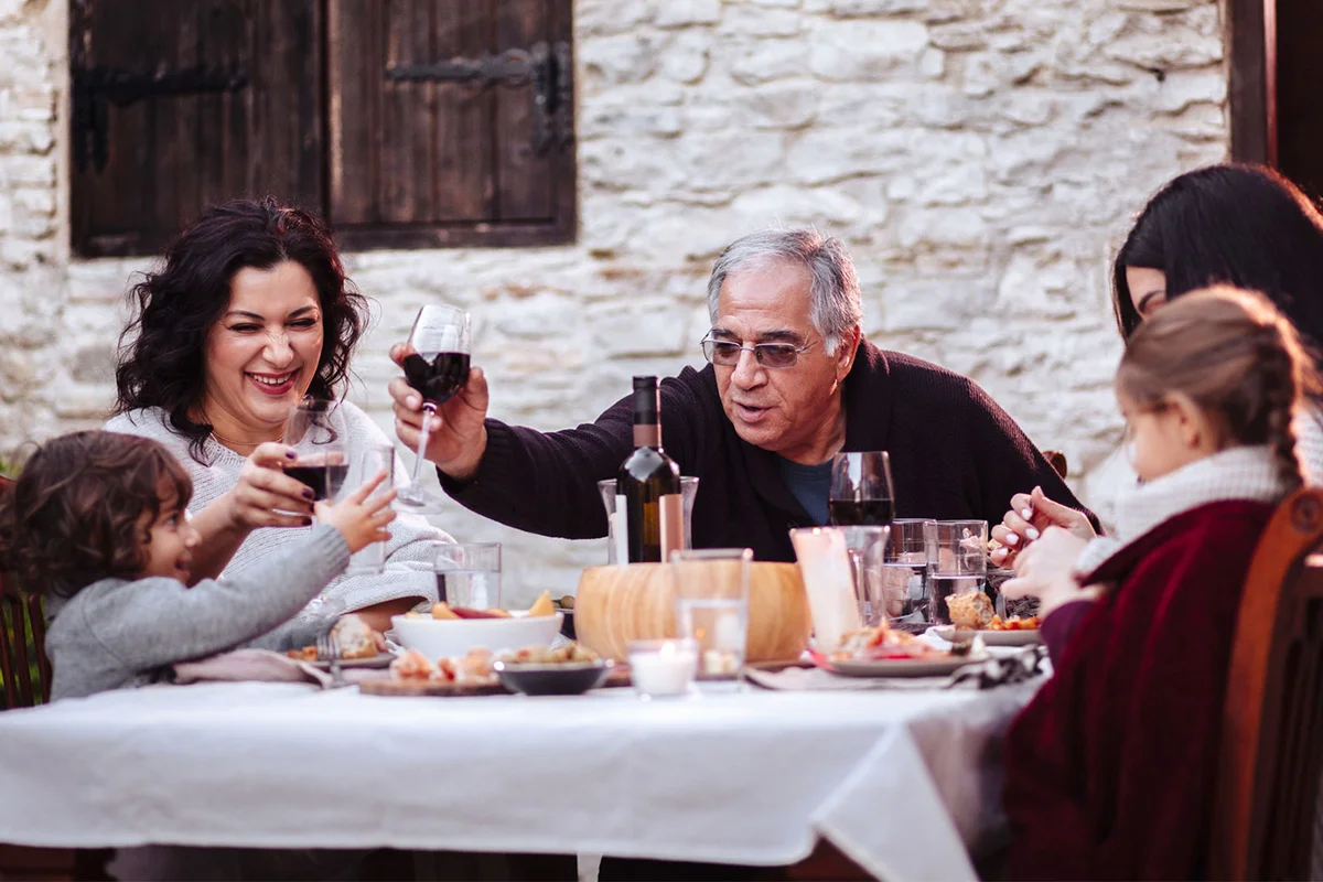 Italian family from Cyprus eating dinner outside