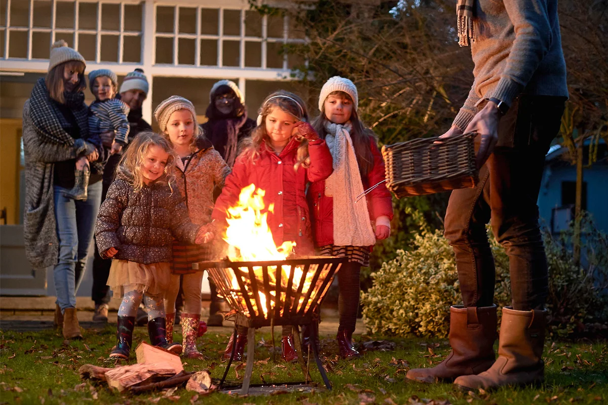 family gathering around fire pit on New Years Eve