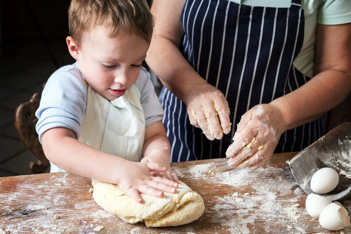 boy baking bread with grandmother