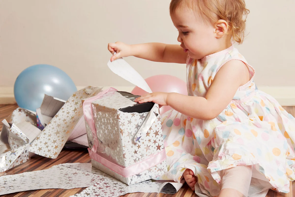 baby girl turning one years old opening gift