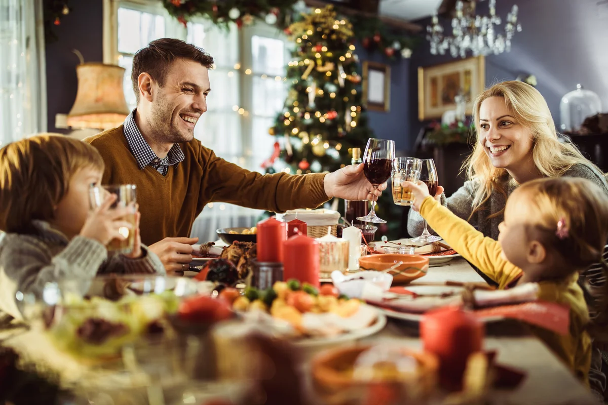 family having formal new years eve dinner toast drinks