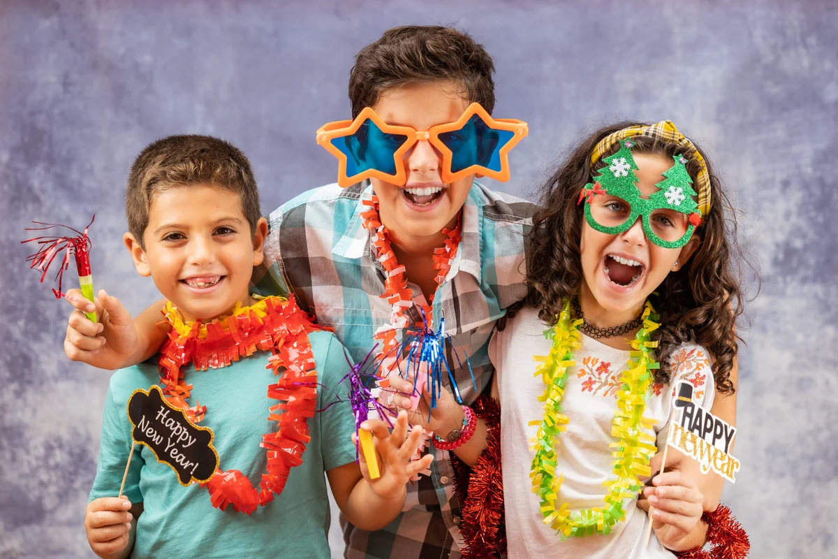 children wearing fun glasses on new years eve