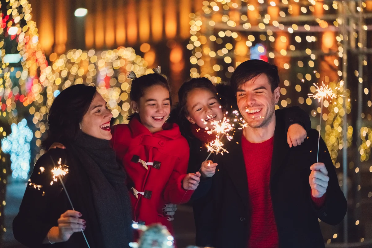 family with sparklers on new years eve