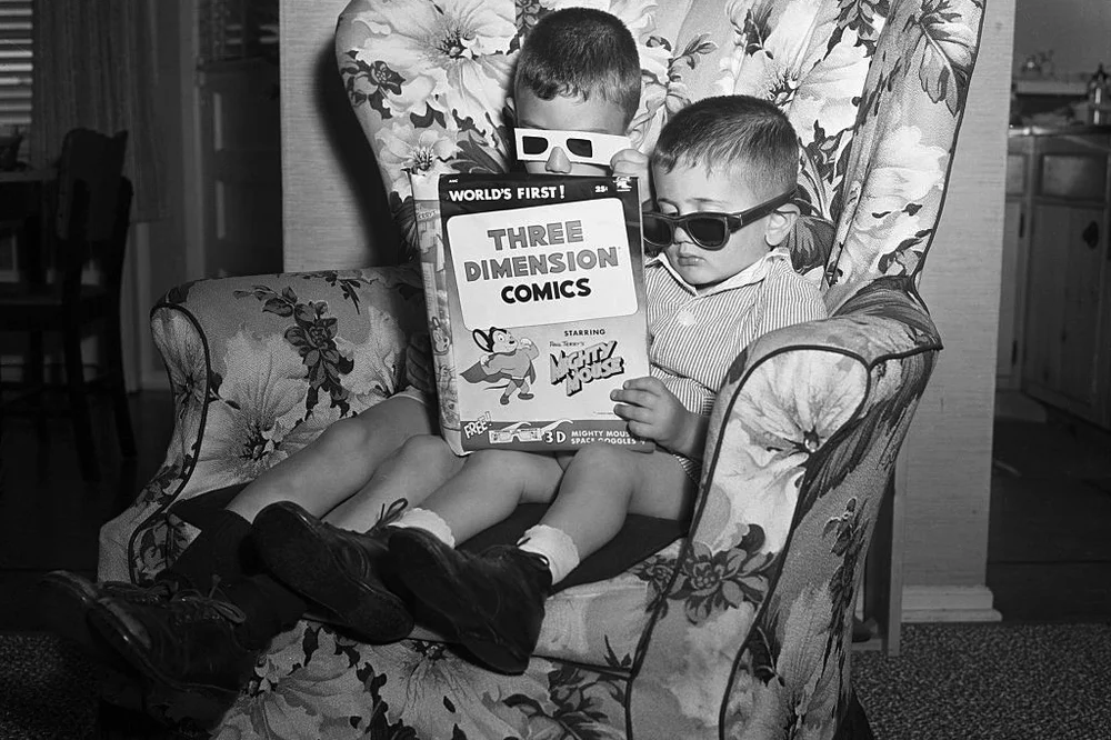 Children wearing 3d glasses to read the mighty mouse 3d edition