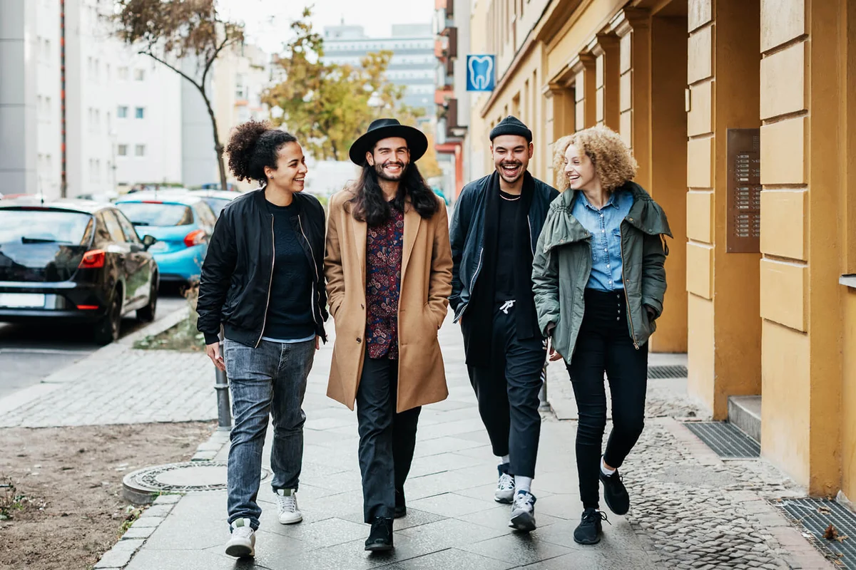 group of friends on chatting while making their way to a bar together for some drinks.