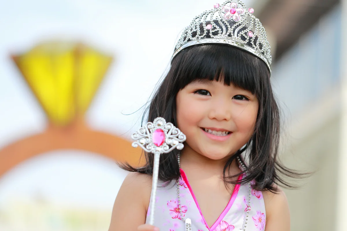 pink princess party girl with pink dress and crown tiara