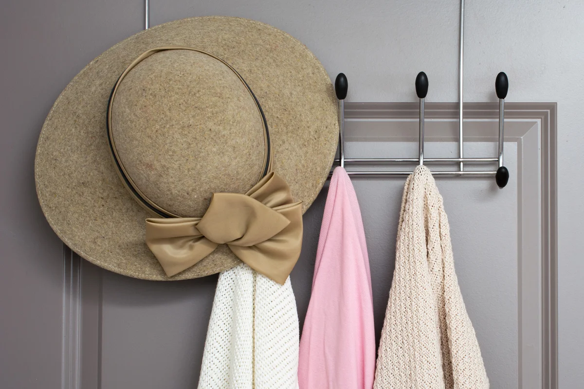 cardigans on a clothes rack inside door