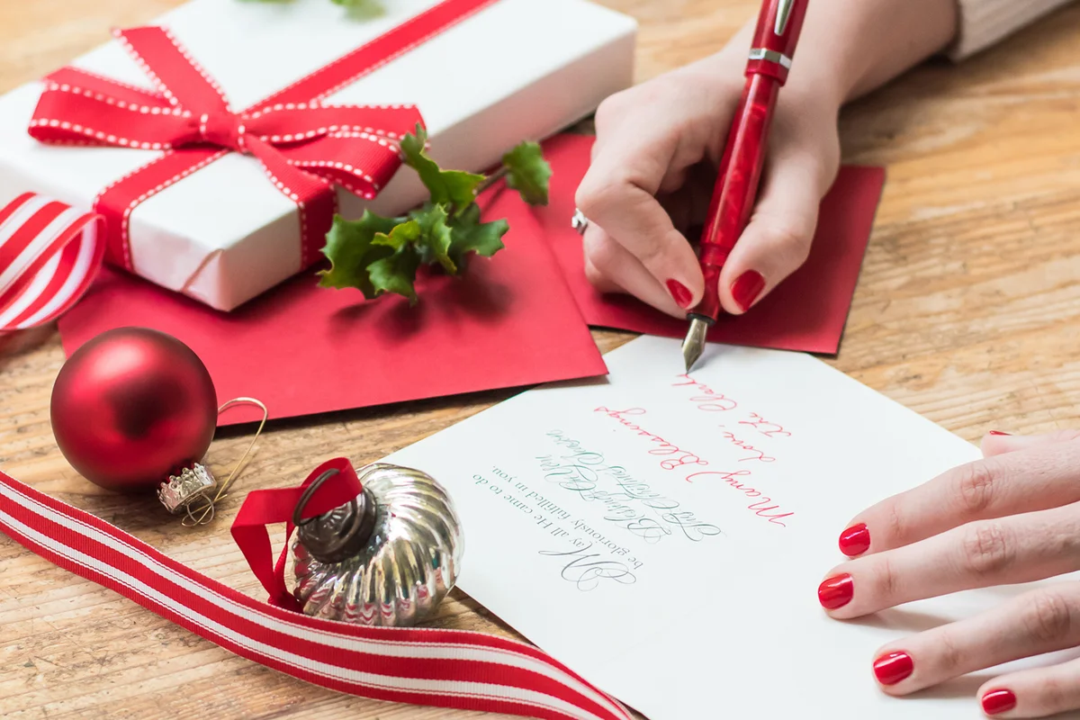 woman writing christmas cards