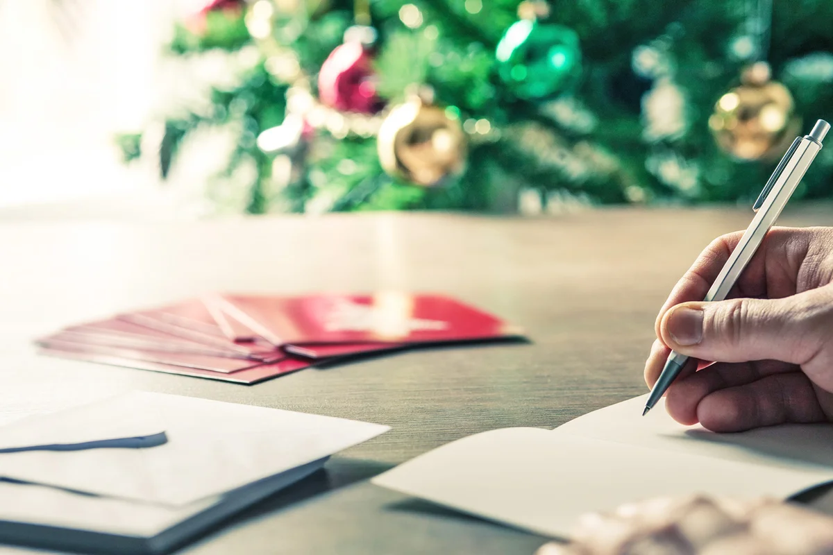 Person writing christmas cards