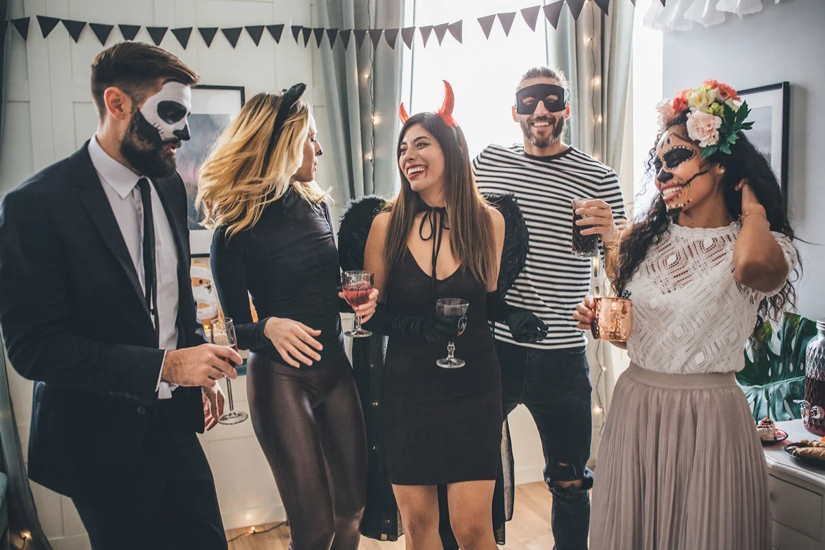 Group of Young people at home celebrating Halloween in costumes
