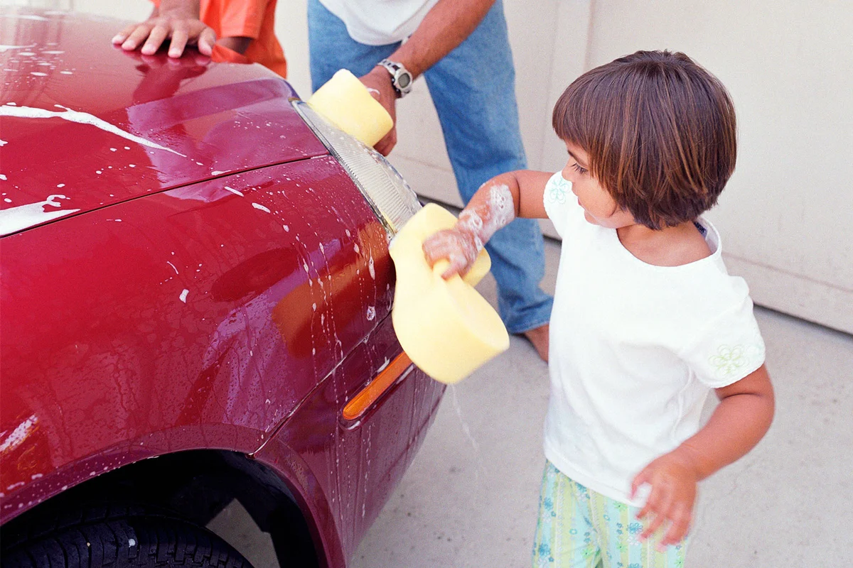 toddler girl washing car