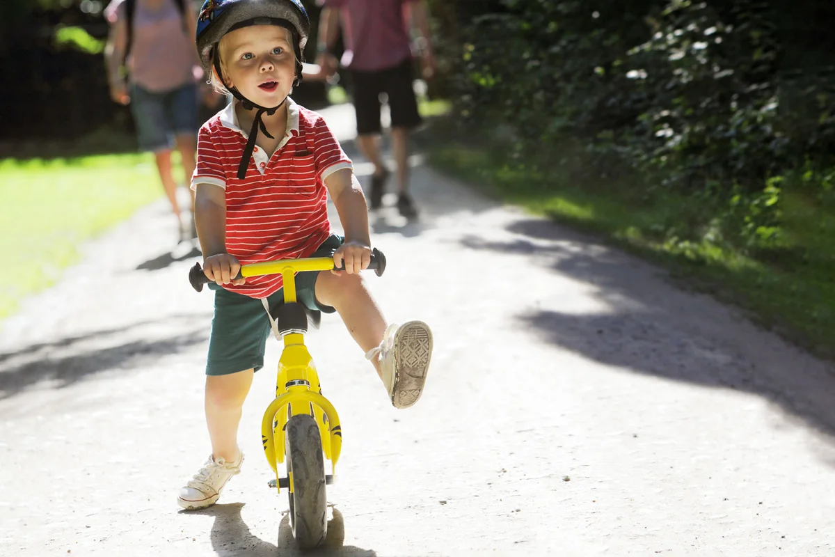 toddler riding a balance bike