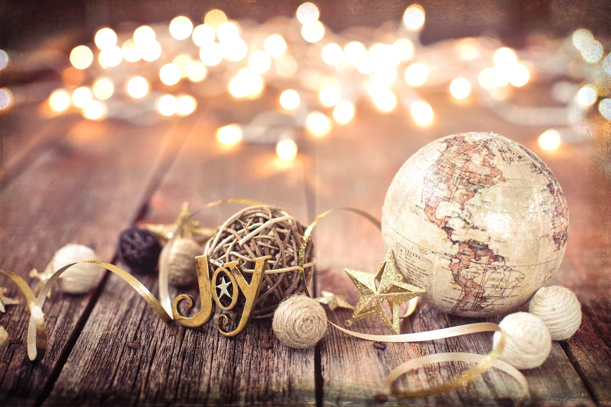Decorations and Globe on Old Wood Background