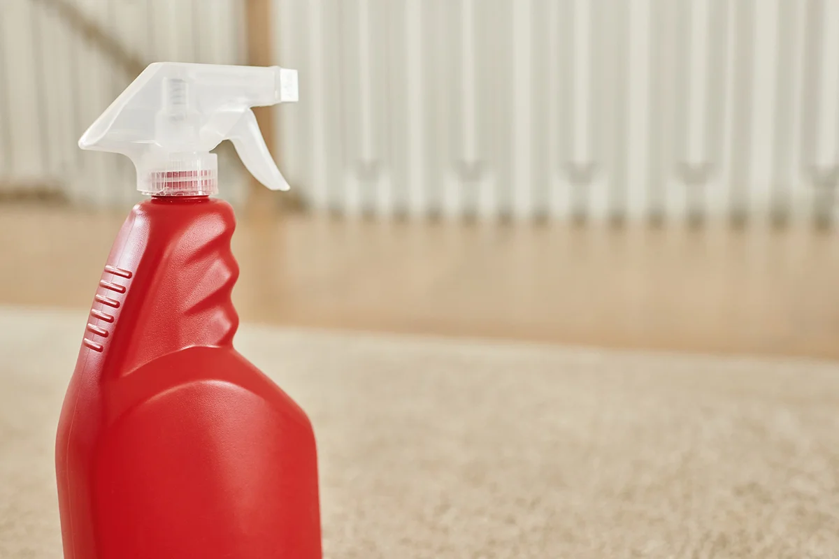 Spray bottle of hydrogen peroxide on beige carpet