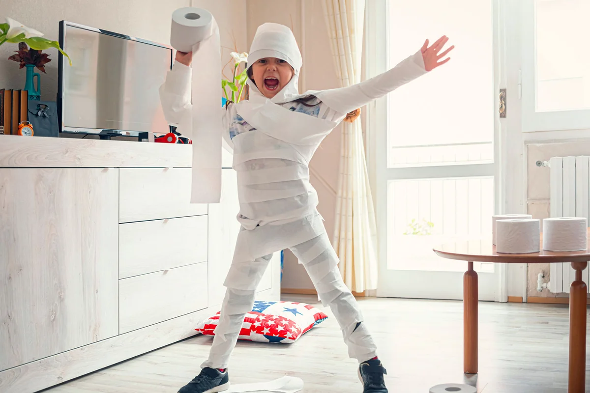 girl wrapped in toilet paper as a mummy