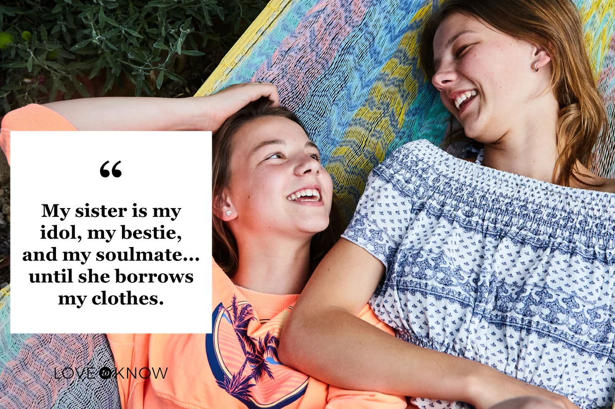two teenage sisters relaxing and having fun together outdoors at home in their garden