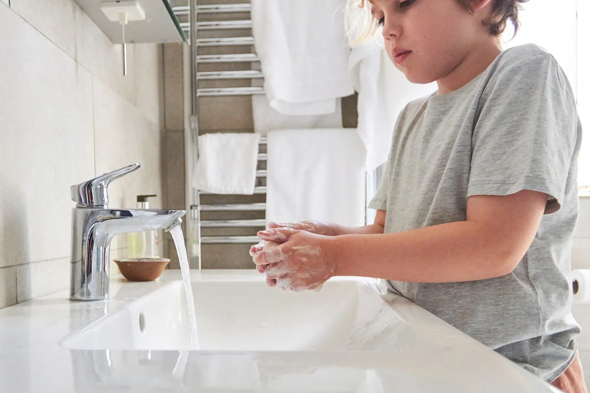 Child washing their hands