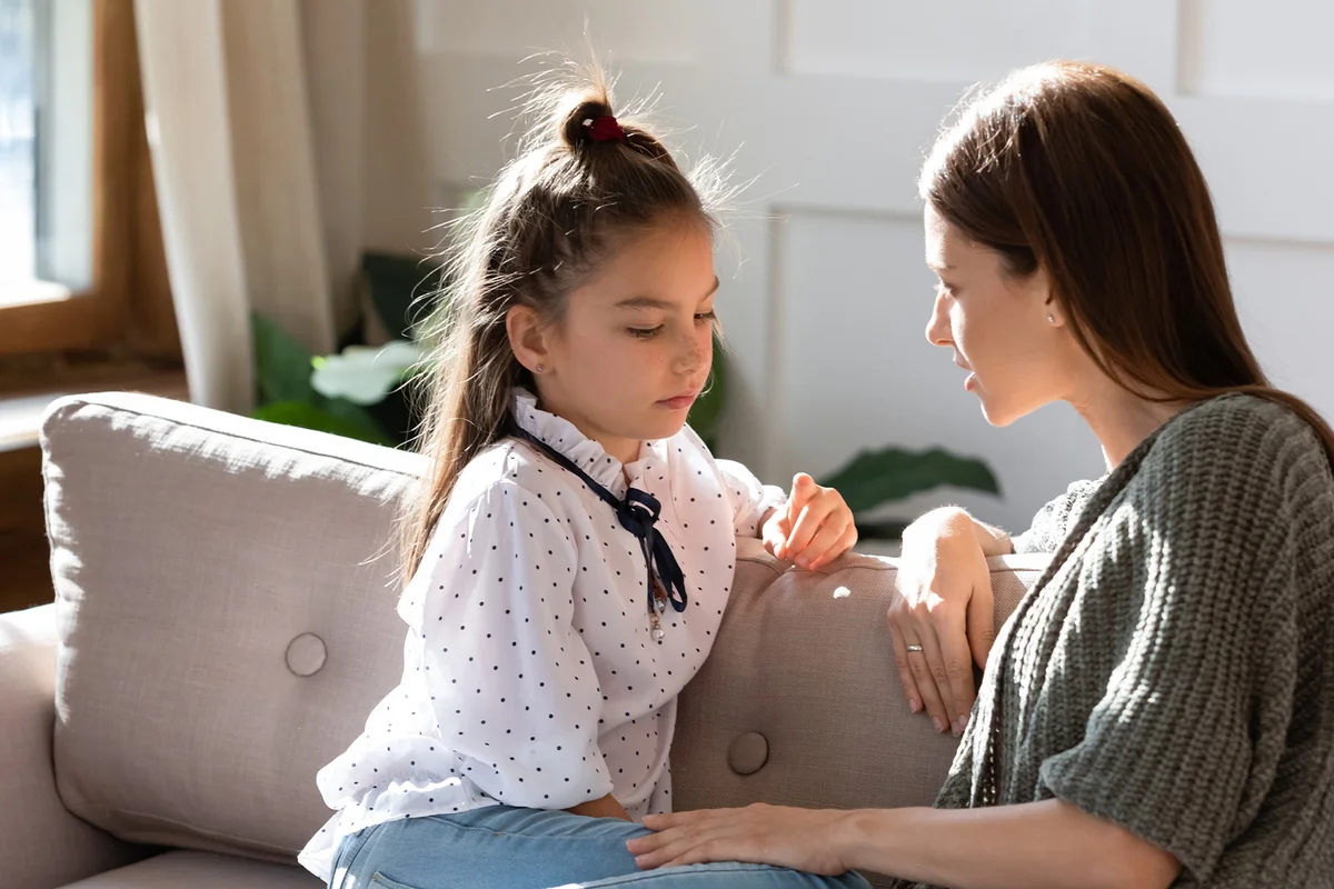 Girl having trustful conversation with mother