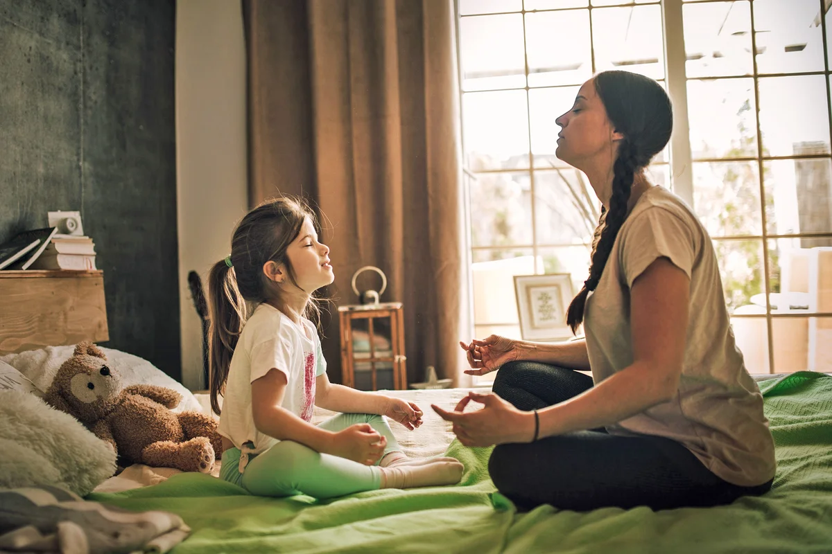 Mother and daughter meditating