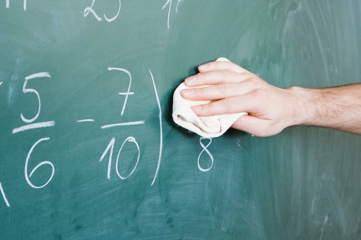 man cleaning a blackboard