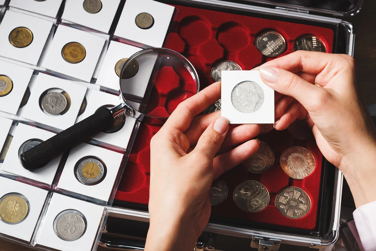 Box with collectible coins and magnifying glass