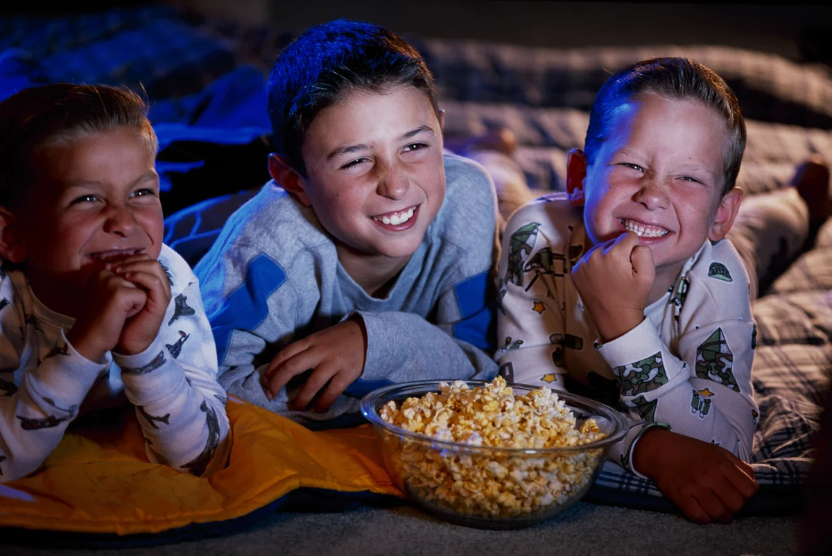 three boys having movie marathon