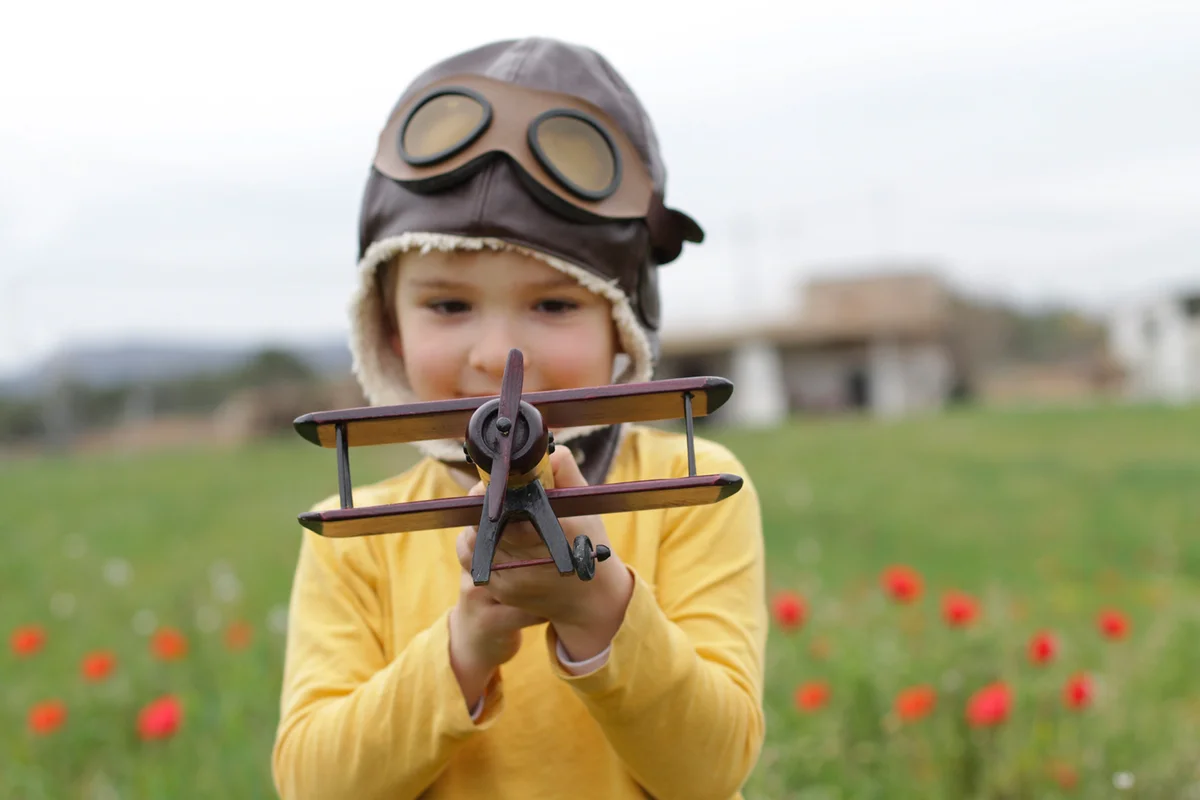 Boy playing with toy airplane