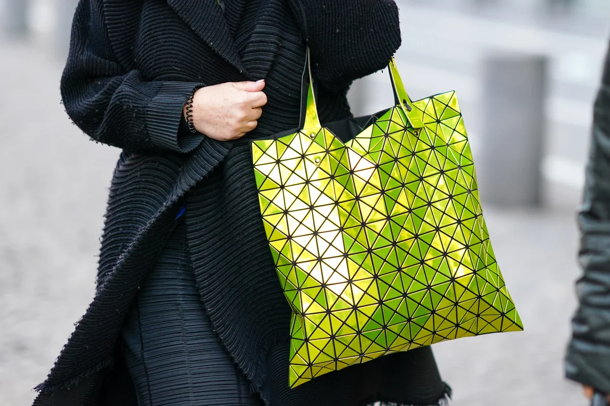 Yellow neon Bao Bao Issey Miyake handbag, outside Berluti, during Paris Fashion Week - Getty Editorial Use