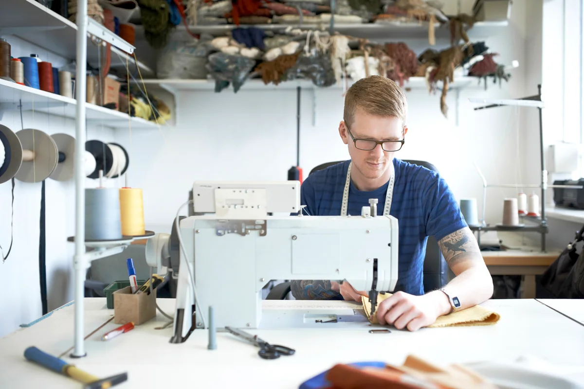 Fashion designer using sewing machine