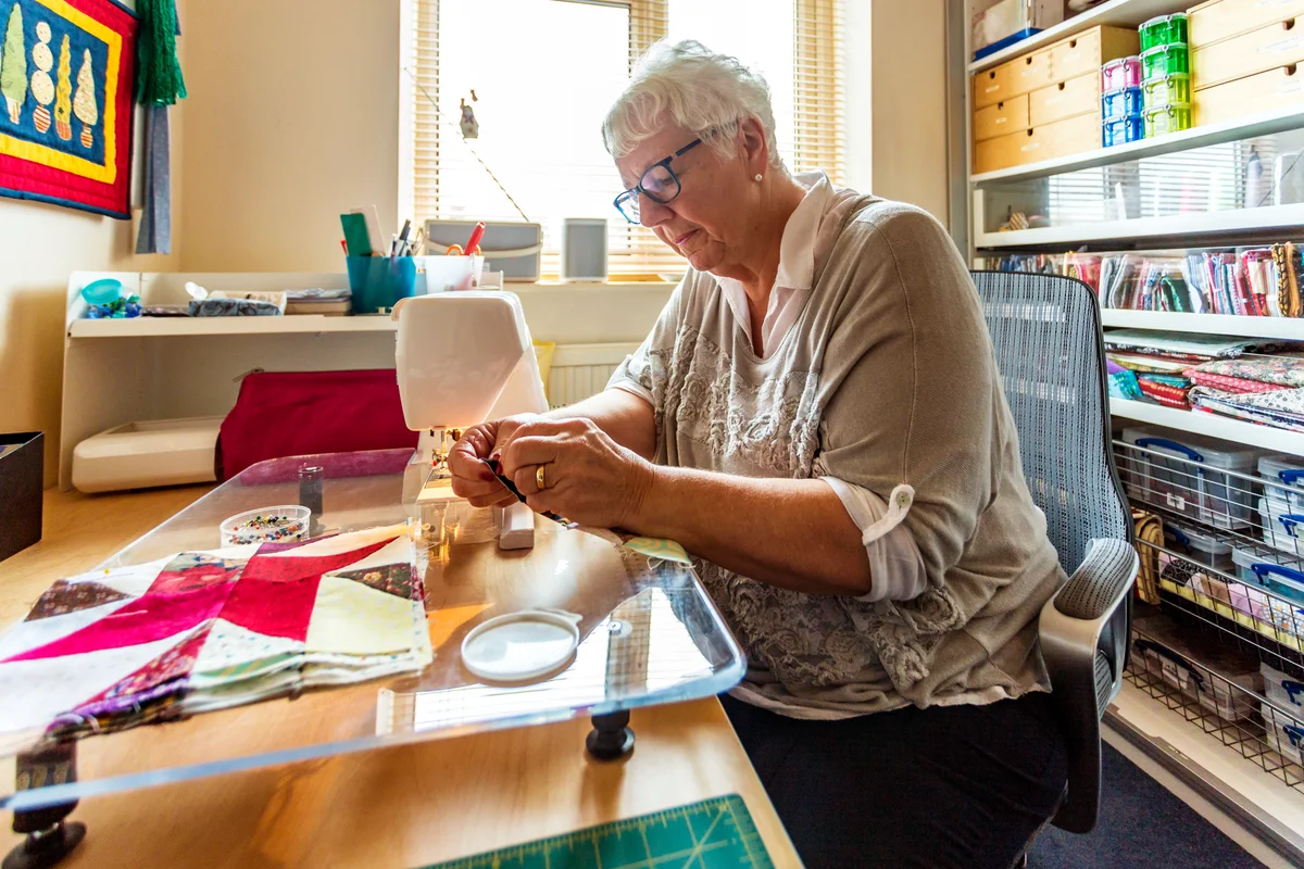 Senior Woman doing her craft in her home sewing room