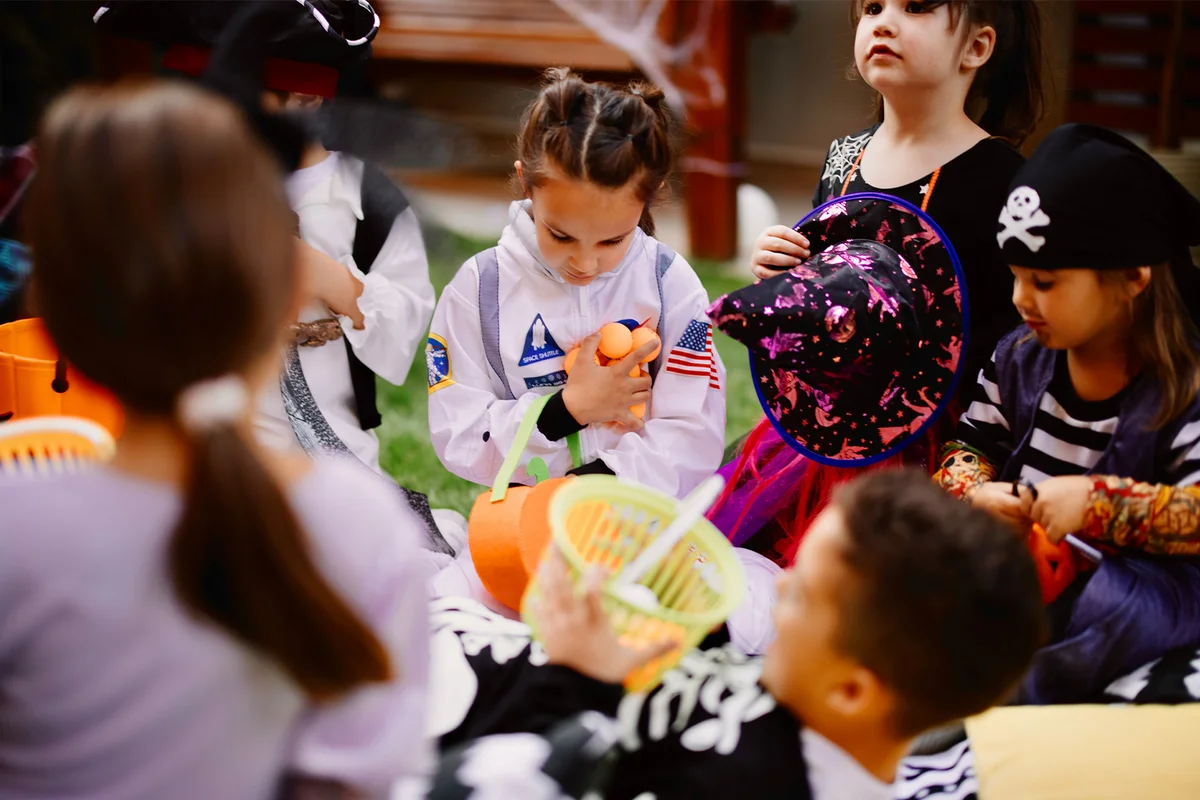 Kids playing Scavenger hunt Halloween game at backyard party