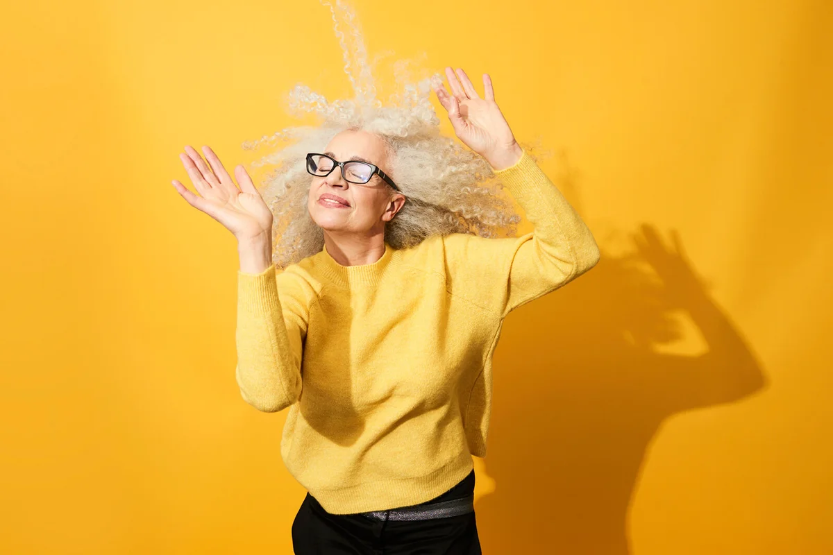 mature woman dancing, smiling and having fun