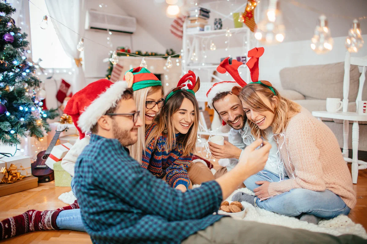 friends posing for a selfie while celebrating Christmas