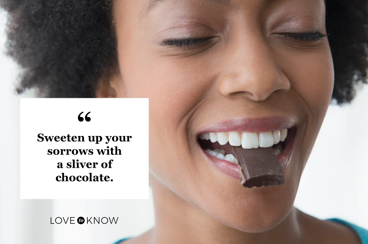 Woman eating square of chocolate