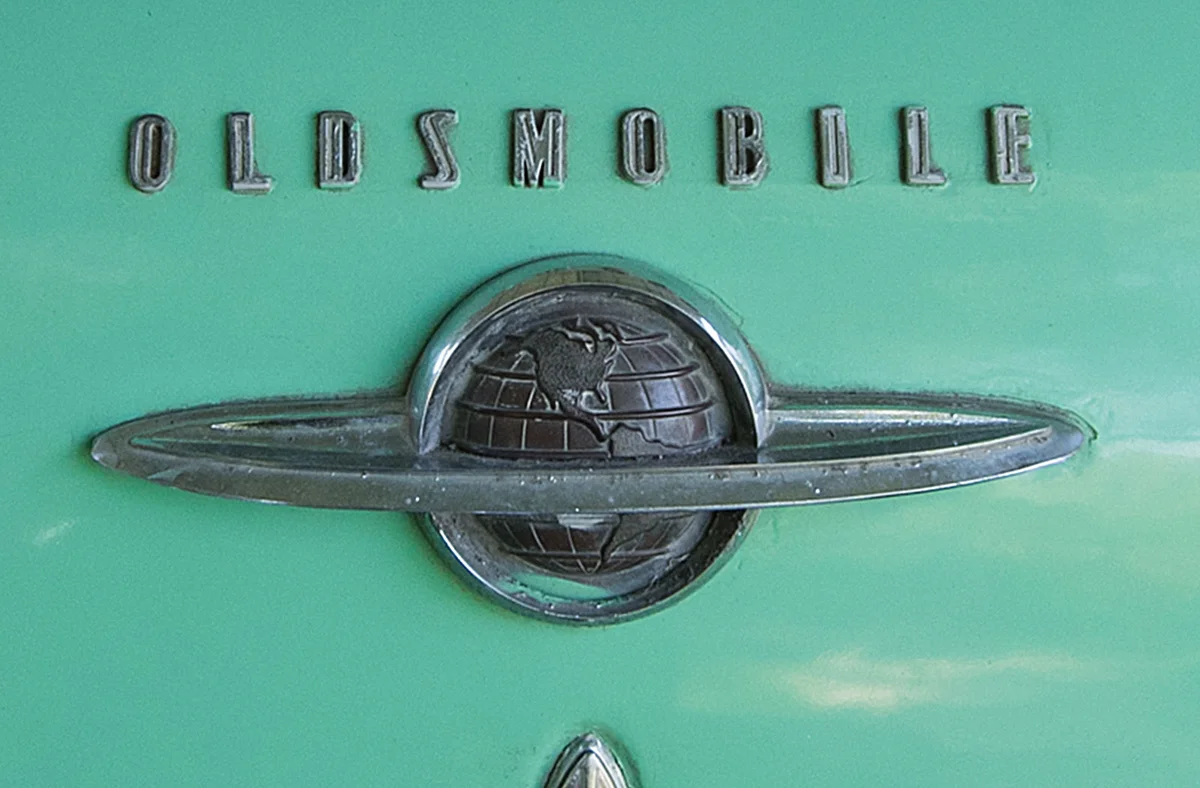 ringed globe badge on antique Oldsmobile automobile