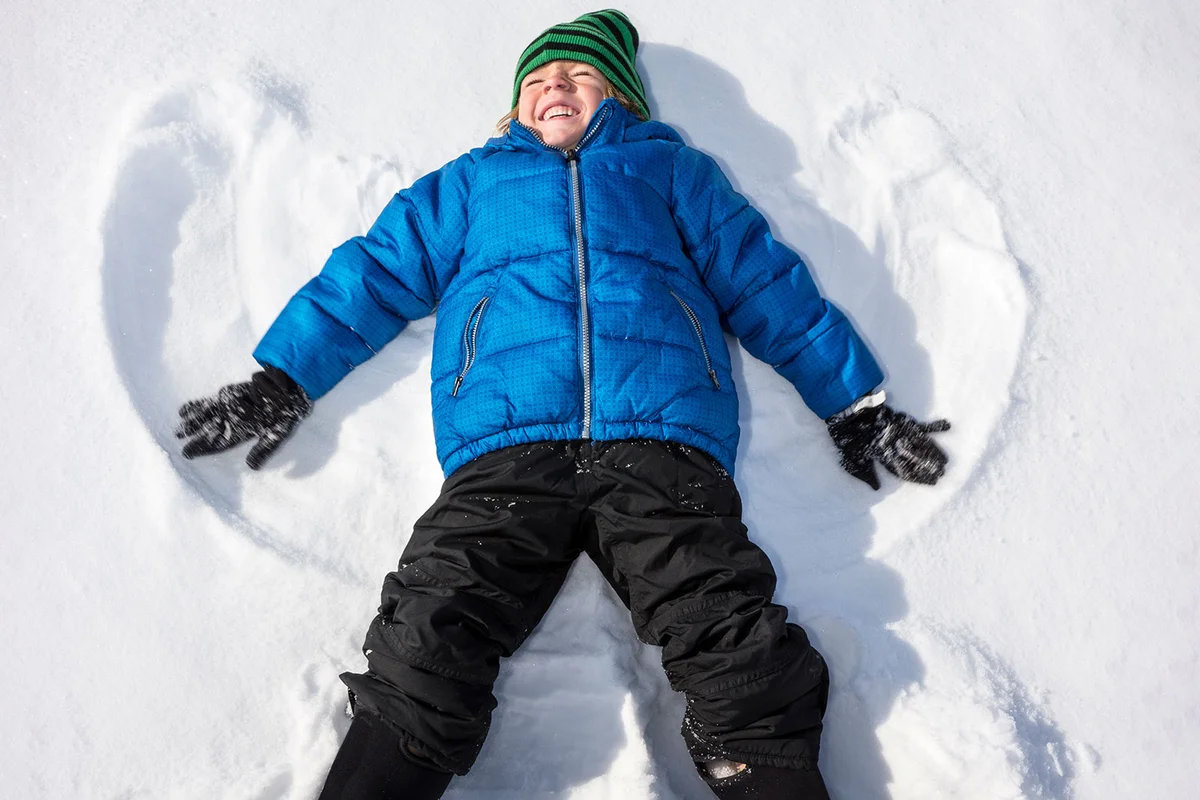 boy making snow angel