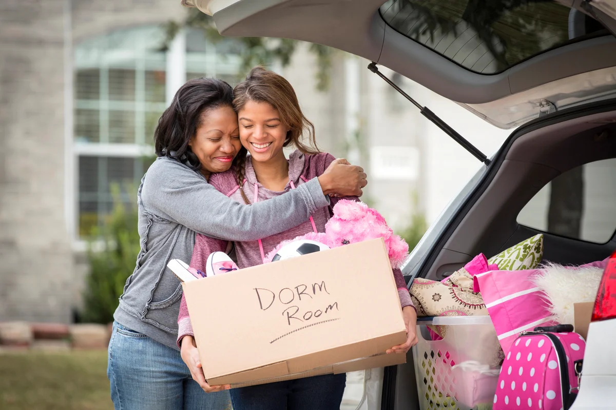 Mother helping daughter pack for college