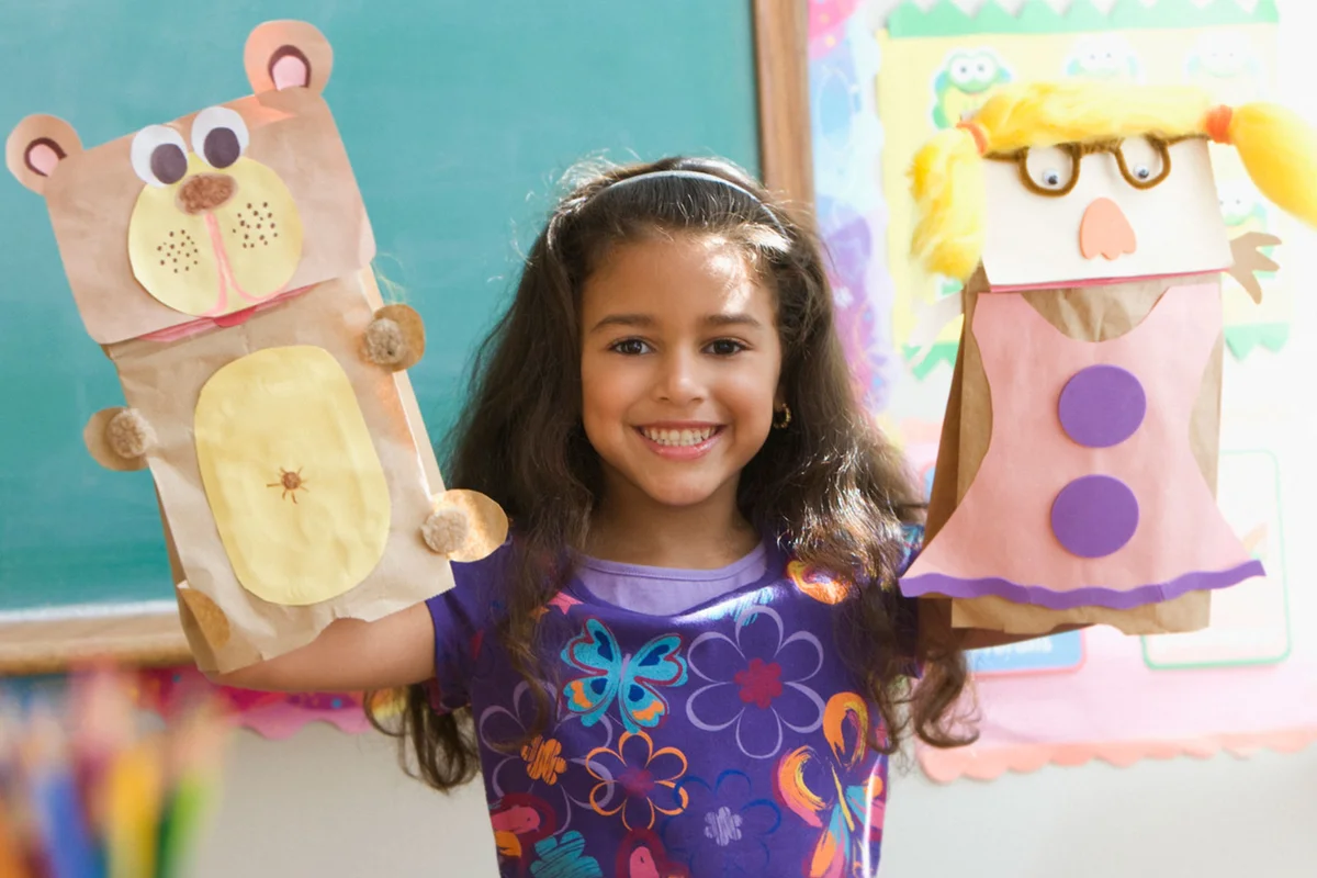 girl with paper bag puppets