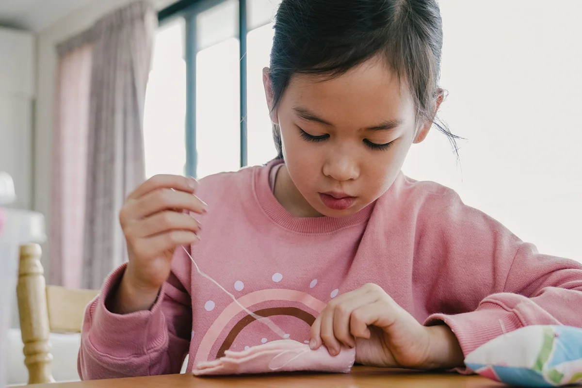girl sewing at home