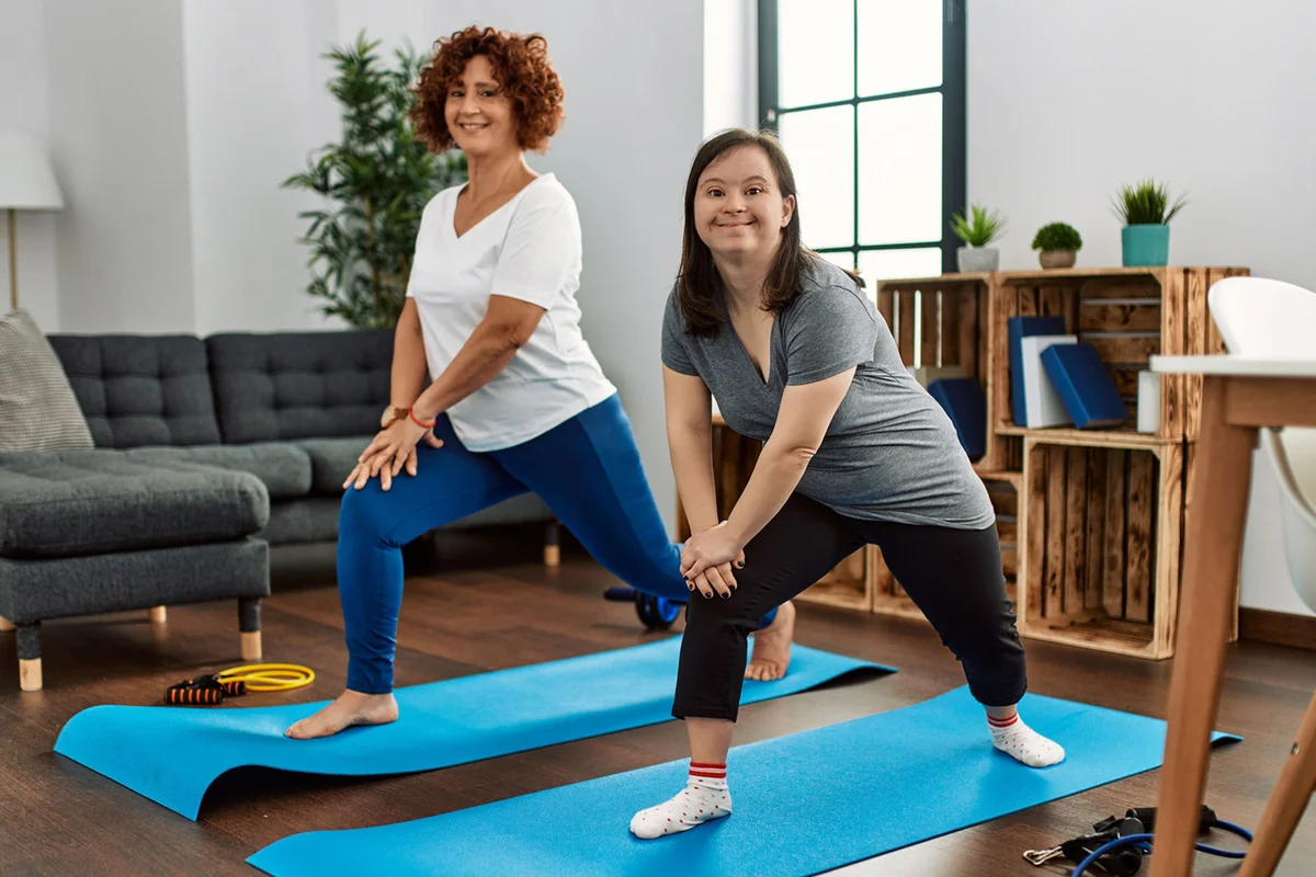 mother and daughter doing yoga together