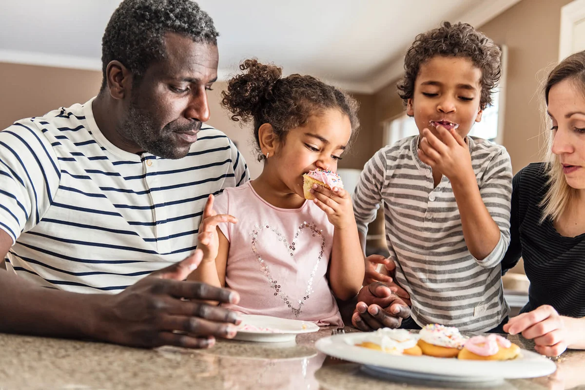 family portrait during Valentine's day, eating cupcakes