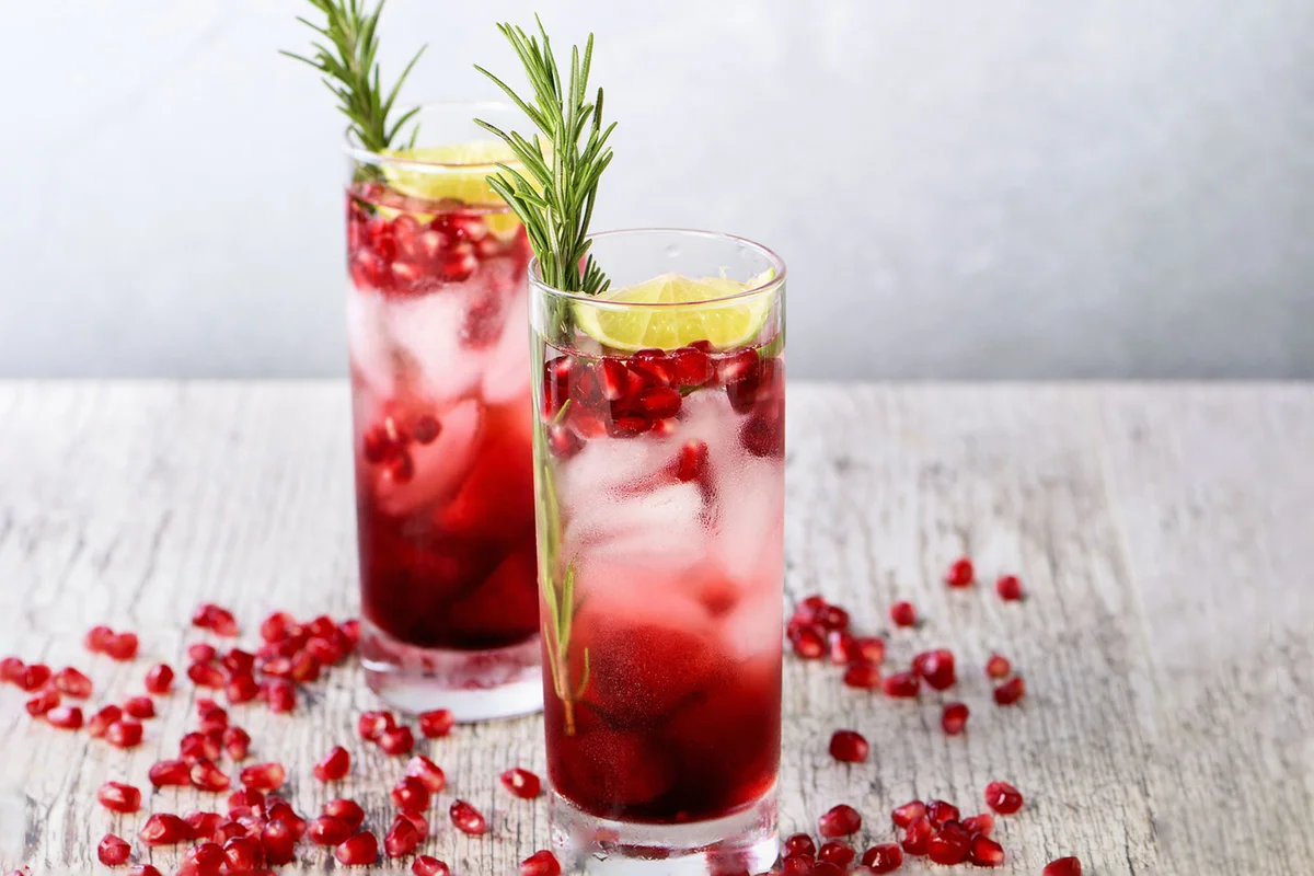 Christmas collins cocktail recipe with rosemary and pomegranate