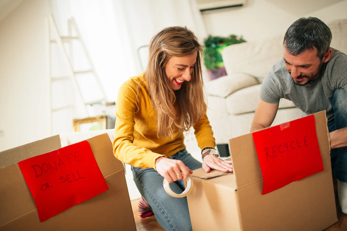 Happy couple packing boxes