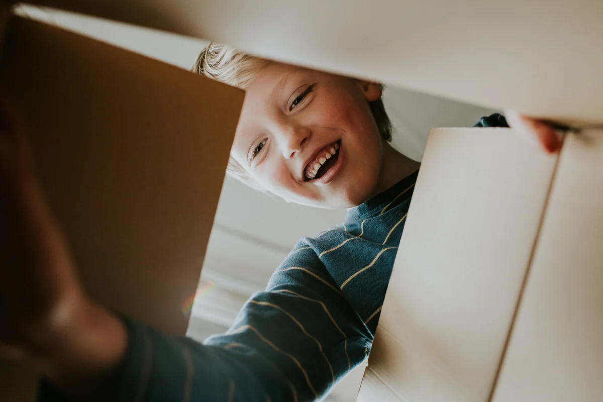 smiling boy opening box