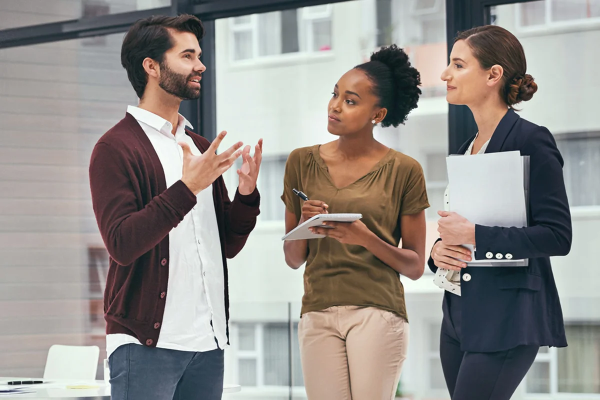 three coworkers discussing work project